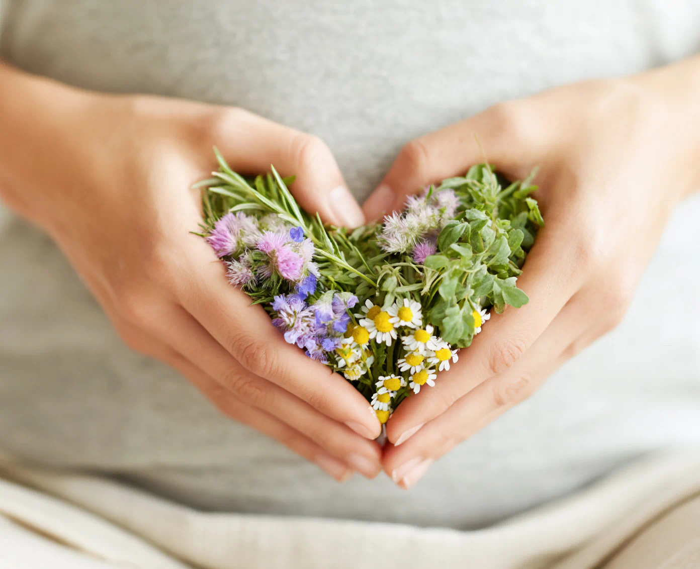 Hands forming shield around glowing liver, symbolizing liver protection